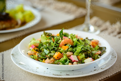 Green salad with shrimp and kani and tropical fruits. Healthy food.