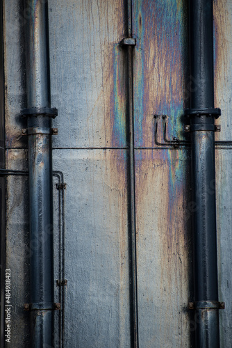 Metal pipes on a metal surface with oil stains.