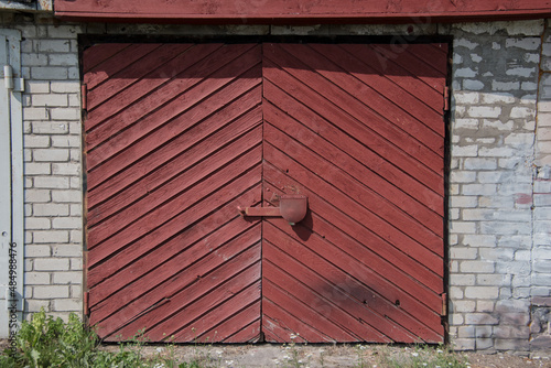 Old wooden garage door in a brick building.