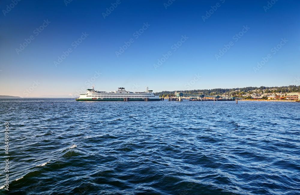 Washington State ferry arrives at the Edmonds dock late on a sunny Summer afternoon