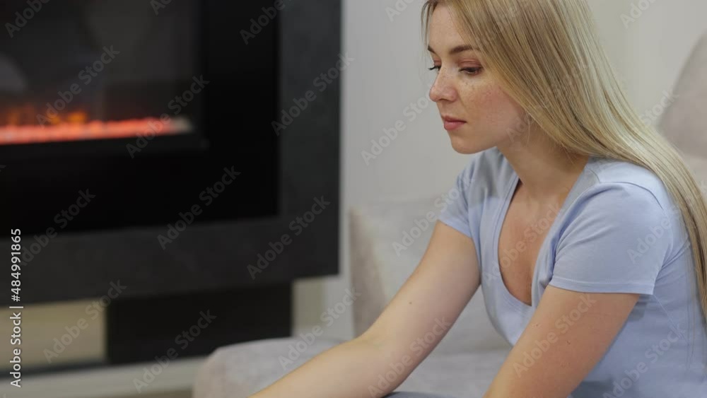A sad woman sits on a sofa and looks at a positive rapid test for coronavirus. . A sad woman sits on a sofa and looks at a positive rapid test for coronavirus. .