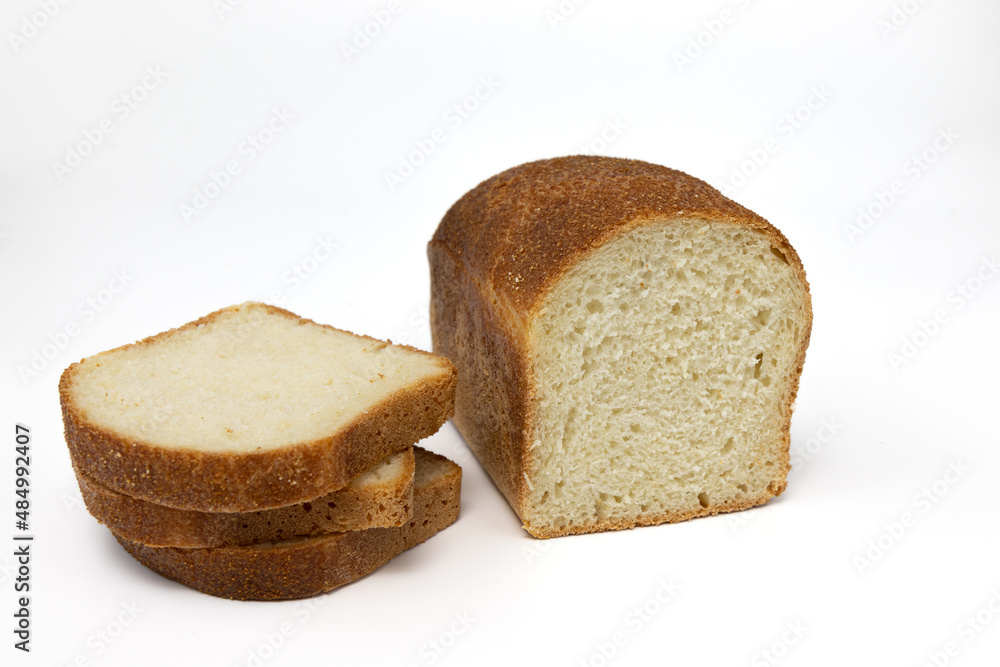 loaf and slices of fresh grain bread on white background loaf and slices of fresh grain bread on white background