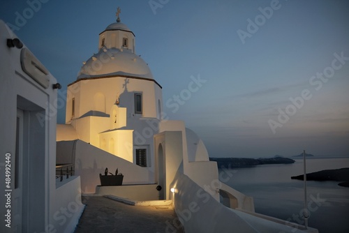 View of a whitewashed Greek Orthodox Church in Fira Santorini Greece at dusk