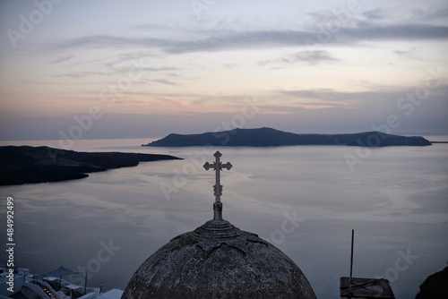 View of the top of a chapel and the sunset at the Aegean Sea