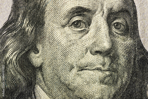 Close up shot of the Benjamin Franklin's face on the 100 Dollar