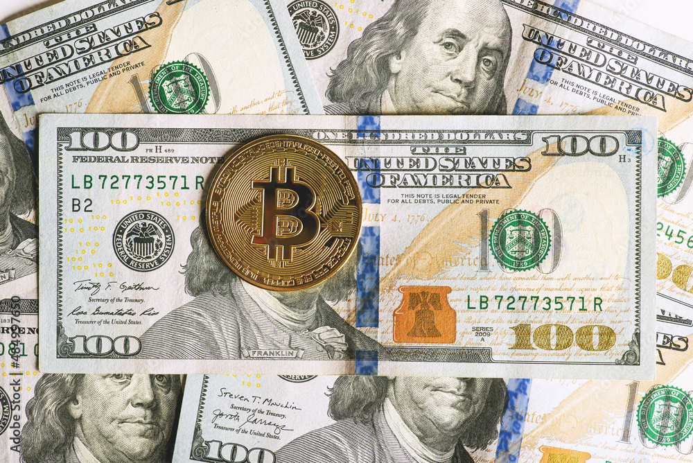 Close-up of bitcoin on benjamin franklin's face on piles of $100 bills Close-up of bitcoin on benjamin franklin's face on piles of $100 bills