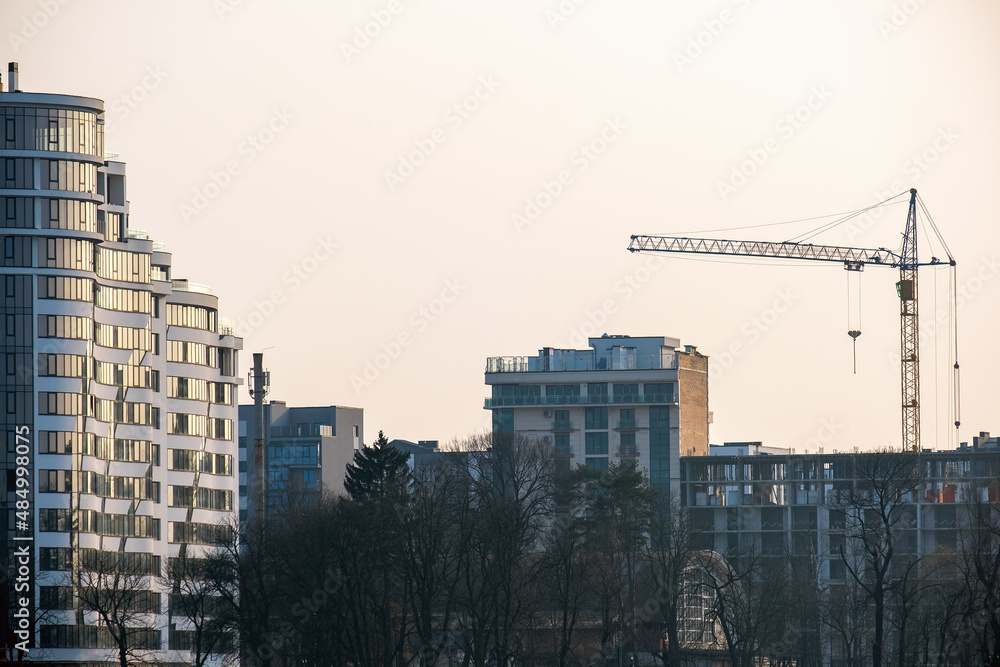 Tower cranes and high residential apartment buildings under construction. Real estate development.