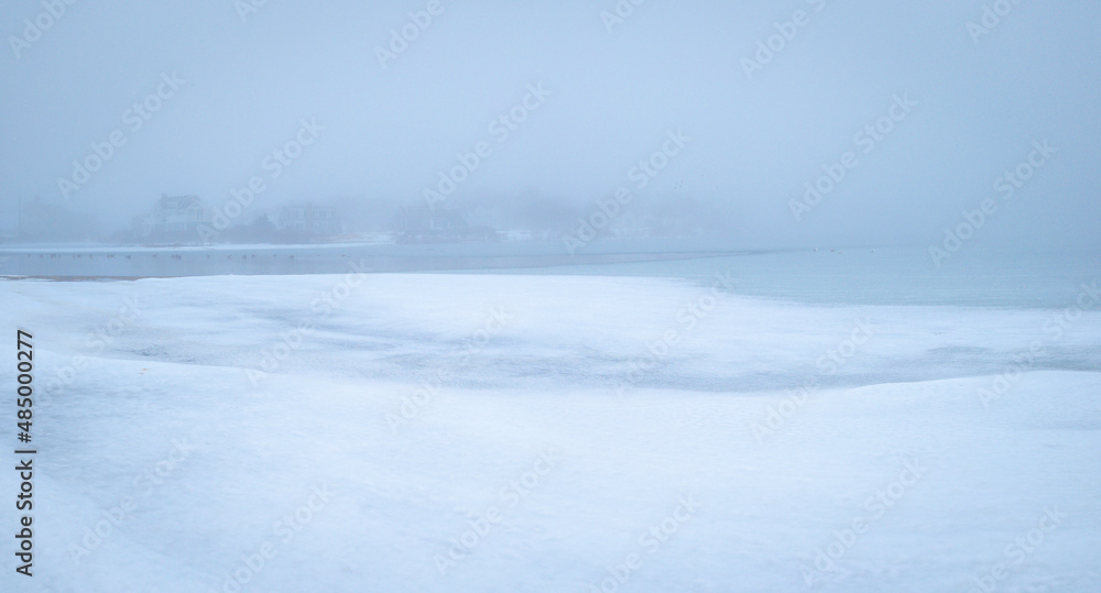 Minimalist winter seascape of the frozen snow-covered coastal beach on Cape Cod. Calm zen-like Asian painting style soft image with space for texts and design. Minimalist winter seascape of the frozen snow-covered coastal beach on Cape Cod. Calm zen-like Asian painting style soft image with space for texts and design.