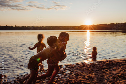 Kids at the beach playing sunset sunrise