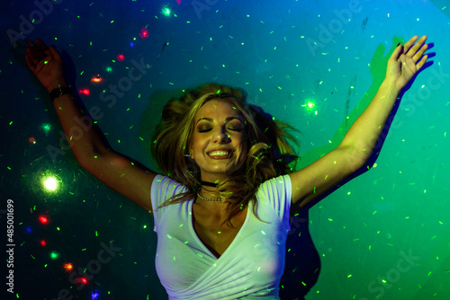 Joyful woman on floor with lights