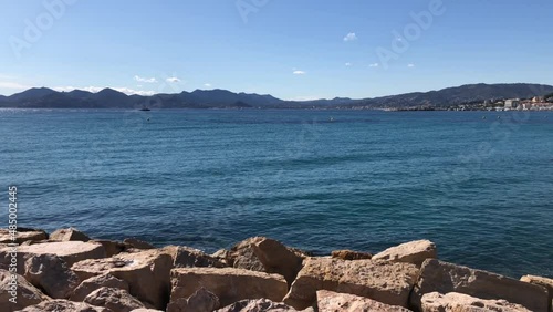 Light waves of a blue sea, rocky coastline