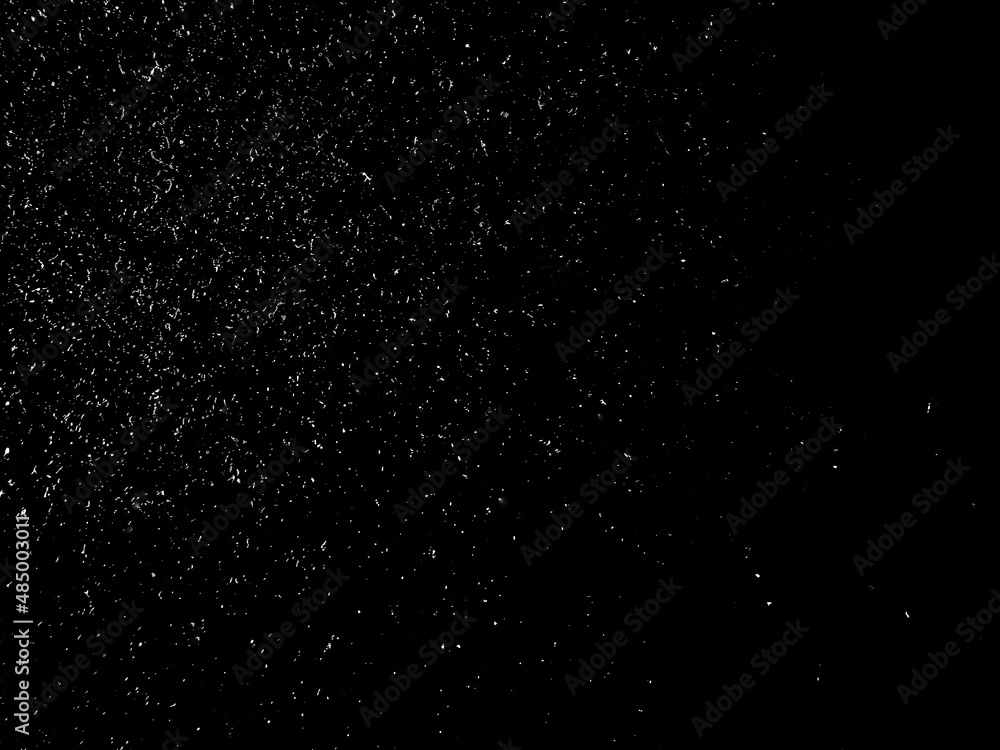 white flakes falling on a black background