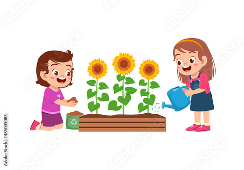 cute little girl stand and watering sun flower