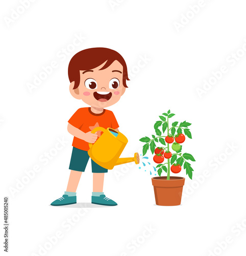 cute little boy stand and watering tomato tree