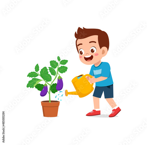 cute little boy stand and watering eggplant tree