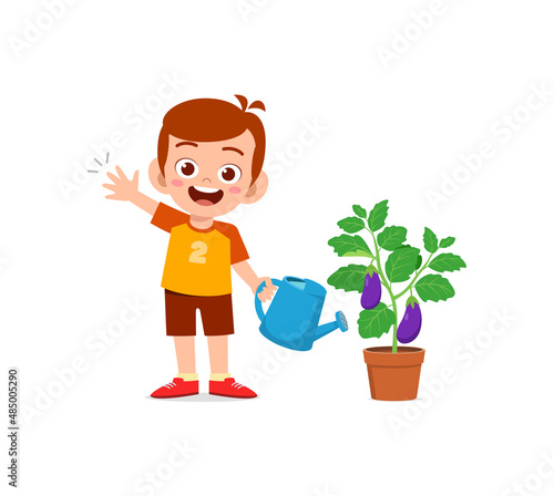 cute little boy stand and watering eggplant tree