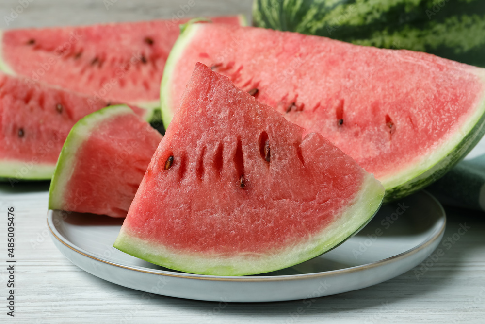 Slices of tasty ripe watermelon on white wooden table, closeup
