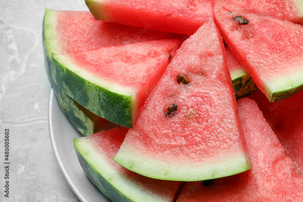 Slices of tasty ripe watermelon on light grey marble table, closeup Slices of tasty ripe watermelon on light grey marble table, closeup