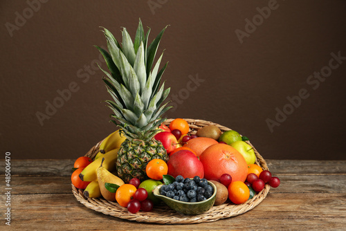 Assortment of fresh exotic fruits on wooden table