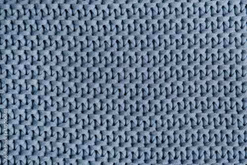 Beautiful light blue knitted fabric as background, top view