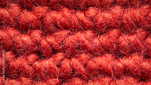 ausschnitt einer roten Wollmütze mit viel Struktur als Hintergrundbild