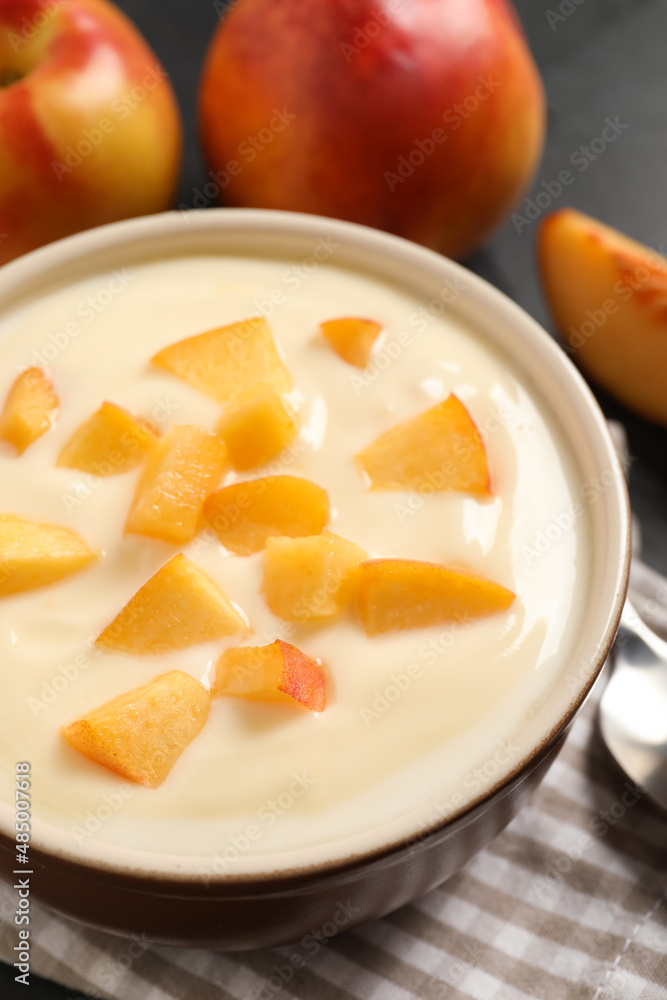 Delicious yogurt with fresh peach on table, closeup Delicious yogurt with fresh peach on table, closeup