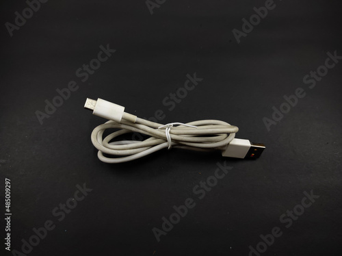 Photo of a white cable isolated on a black background, Not Focus