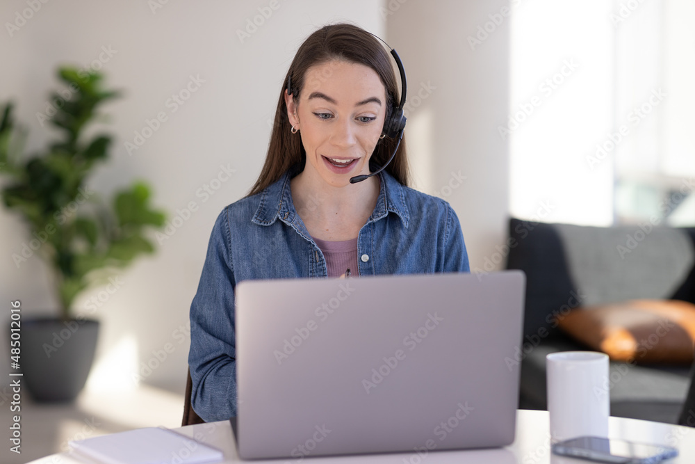Caucasian woman at home remote working on laptop computer talking to her colleague Caucasian woman at home remote working on laptop computer talking to her colleague