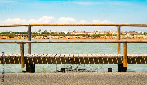Skyline framed by a wooden bridge, in the Salinas de San Pedro del Pinatar, Murcia, Spain.