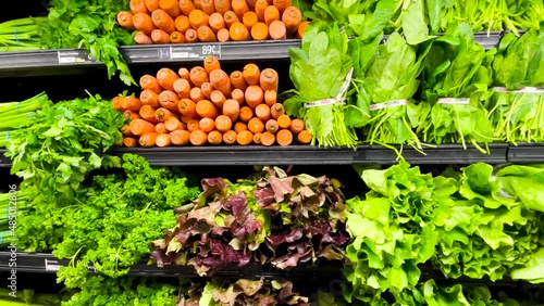 Slow pan of a beautiful fresh produce wall in a retail grocery store