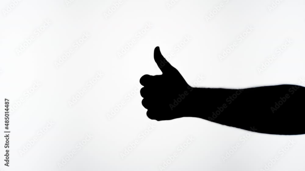 Man showing like gesture with fingers isolated on white background. Male person holding hand shadow silhouette close-up, thumb up. Man showing like gesture with fingers isolated on white background. Male person holding hand shadow silhouette close-up, thumb up.