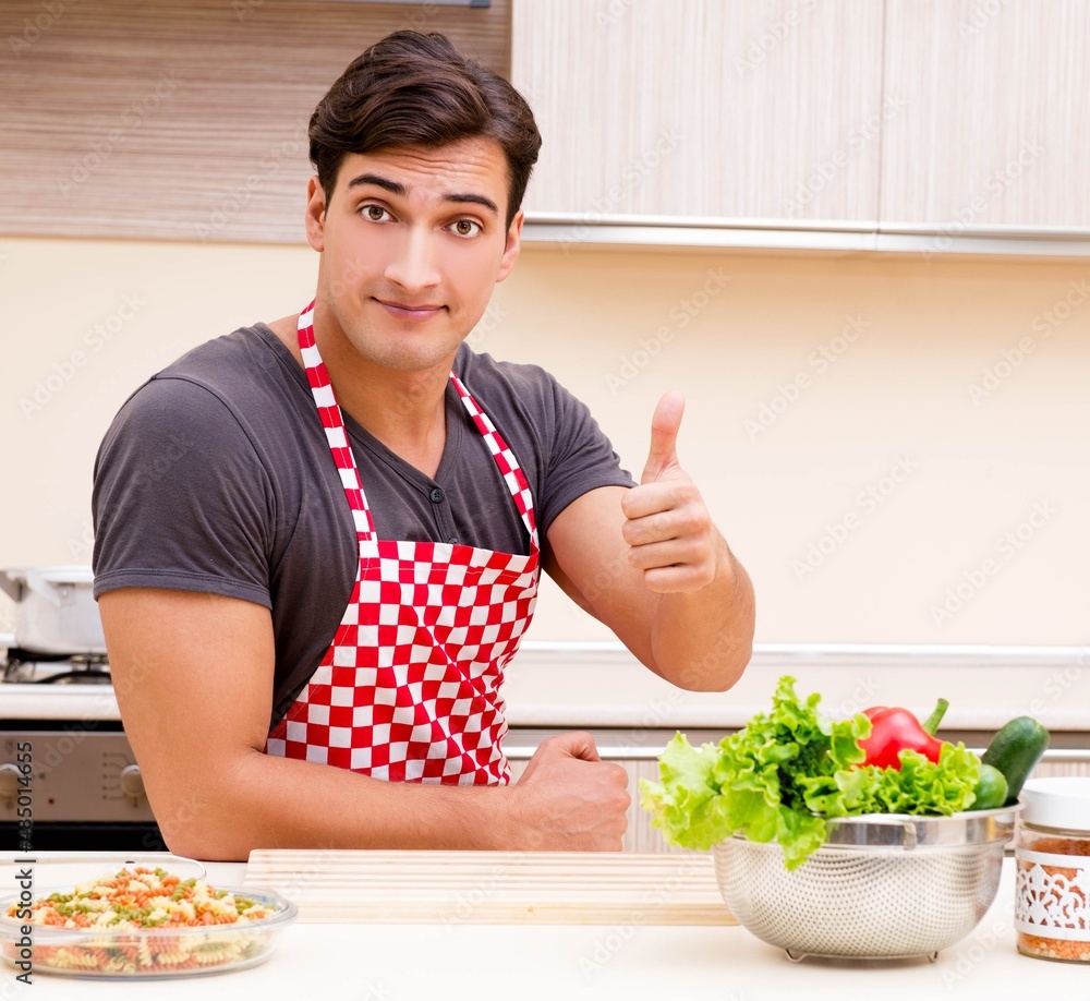 Man male cook preparing food in kitchen Man male cook preparing food in kitchen