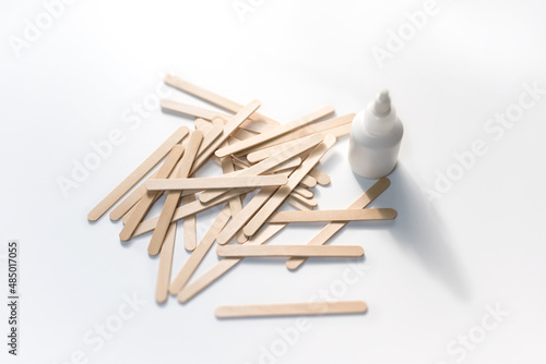 Building material. Making things from wooden Popsicle sticks (also called as wooden craft sticks) photo