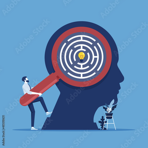 Businessman use magnifying glass to search idea in businessman head, searching for good idea concept