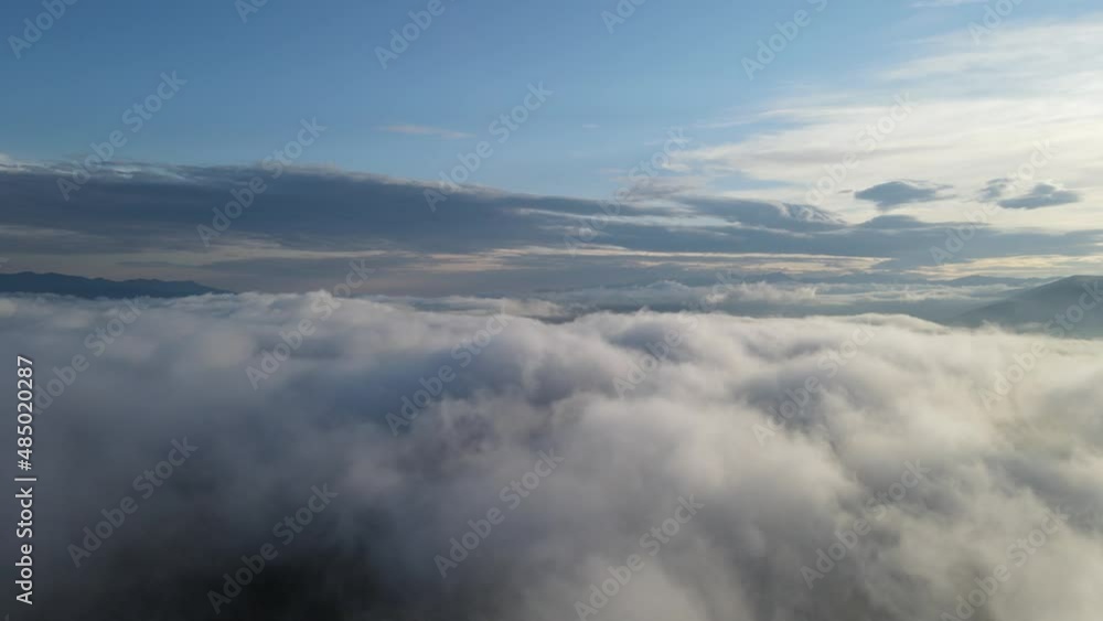 flight over the Chivirkuy spit through the clouds at dawn flight over the Chivirkuy spit through the clouds at dawn