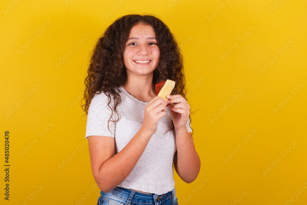 Obraz na plátně Afro-Brazilian, latin-american girl with curly hair smiling, holding skewers of