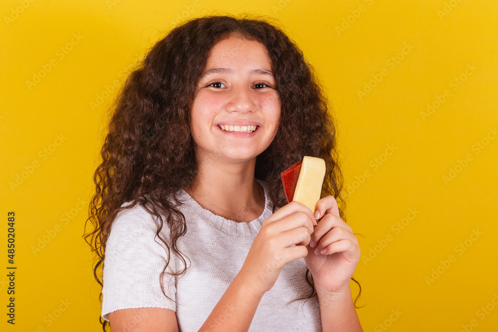 Φωτογραφία Afro-Brazilian, latin-american girl with curly hair smiling, holding skewers of