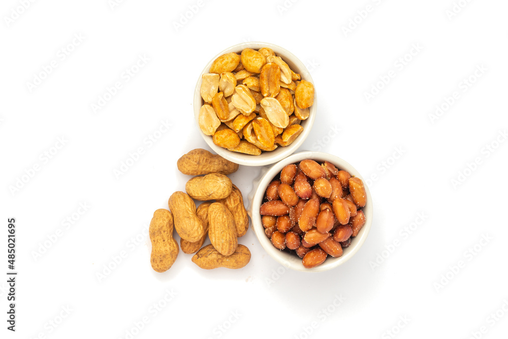 Three varieties of peanuts in bowls on the white background with space for text. Three varieties of peanuts in bowls on the white background with space for text.