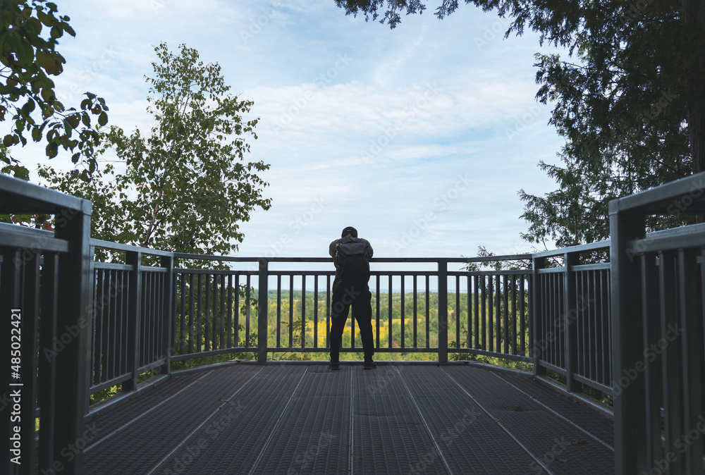 Tourist Admiring View of Nature on Steel Balcony in Provincial Park