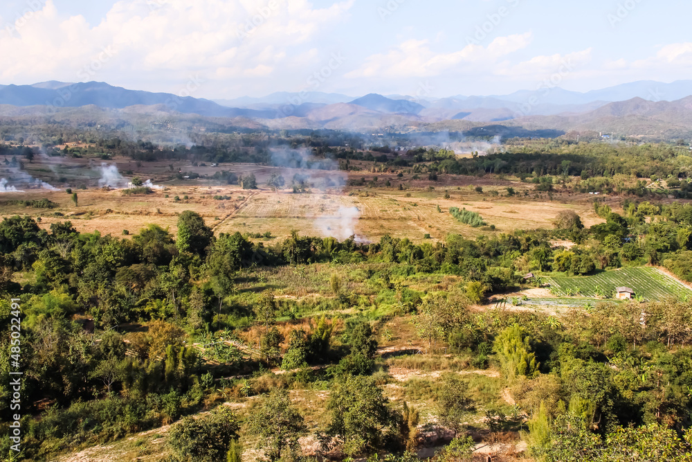 Close up smoke from burning at rice farm for agriculture on mountains view landscape and blue sky background in Chiang Mai , Thailand Close up smoke from burning at rice farm for agriculture on mountains view landscape and blue sky background in Chiang Mai , Thailand