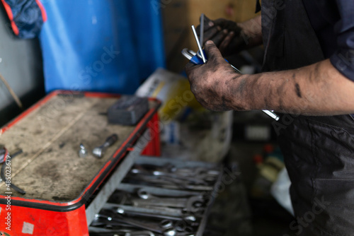 Close-up image of car service worker, taking tools from box for mechanical instruments.