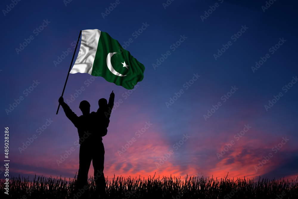 Father and son hold the flag of Pakistan