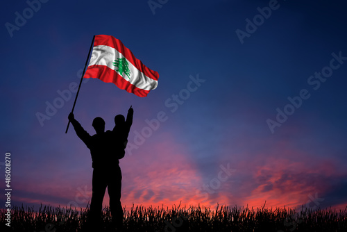 Father and son hold the flag of Lebanon