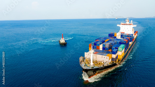 Container ship was dragged by tug boat to international cargo port for service transportation ,logistic service transportation and maintenance concept