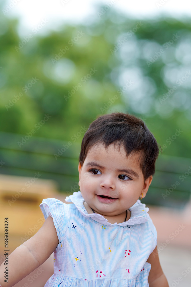 Indian baby girl child playing and giving smile Indian baby girl child playing and giving smile