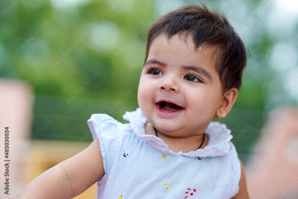 Indian baby girl child playing and giving smile Indian baby girl child playing and giving smile