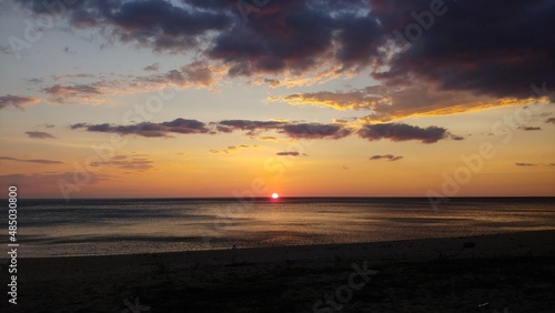 The beach where the sunrise with the clouds