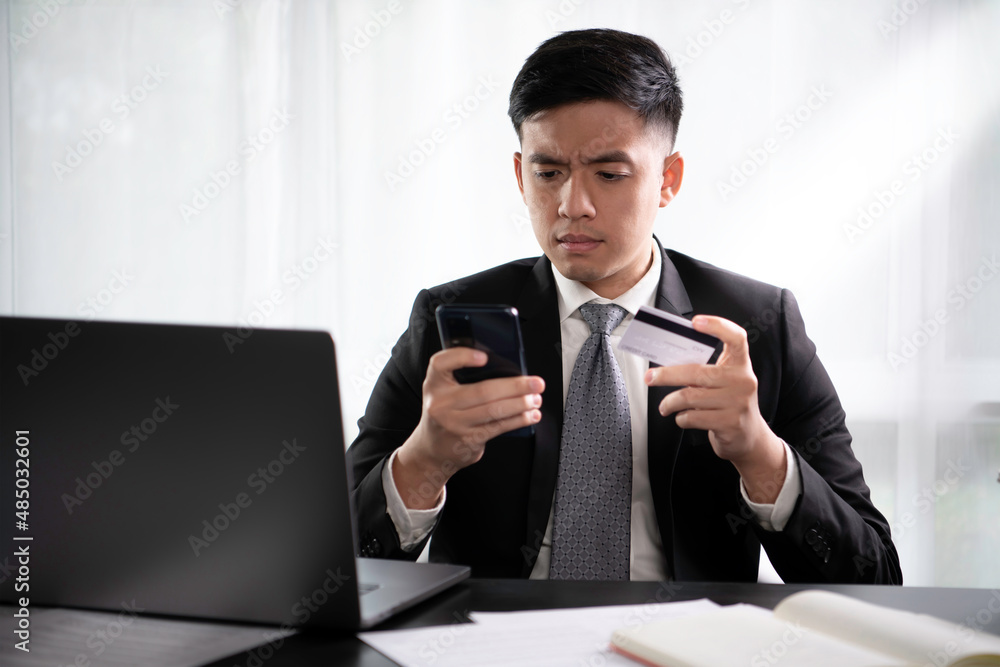 Asian businessman looking stressed and displeased while making unsuccessful online digital payment using electronic banking application. Entrepreneur upset with connection failure Asian businessman looking stressed and displeased while making unsuccessful online digital payment using electronic banking application. Entrepreneur upset with connection failure