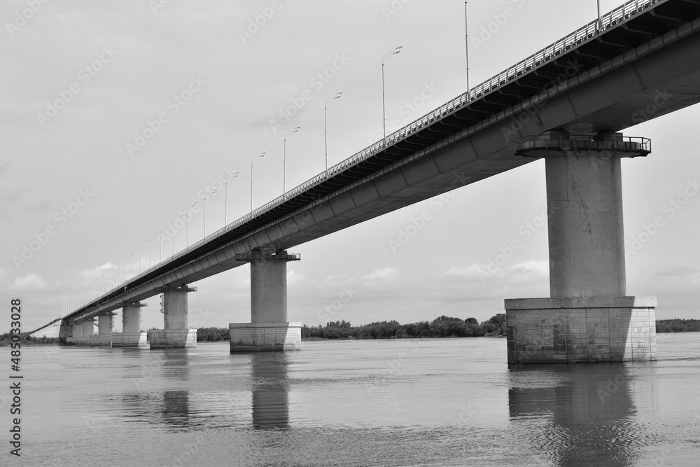 View of the bridge over the river. Black and white photo. View of the bridge over the river. Black and white photo.