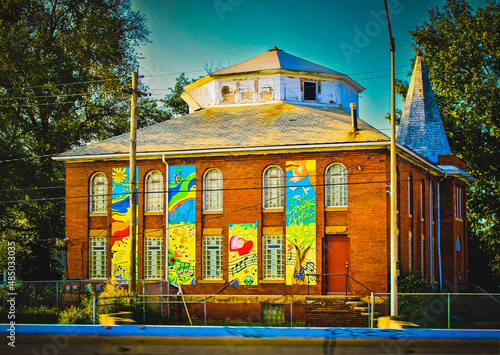 A large brick building with music-themed murals painted on the front on the west side of Cleveland, Ohio